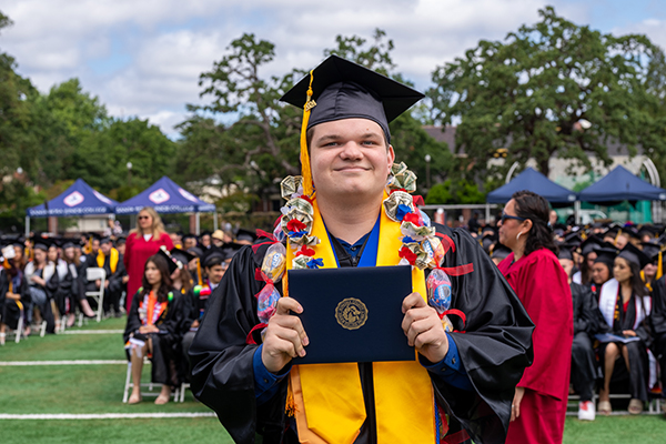 Student holding their diploma